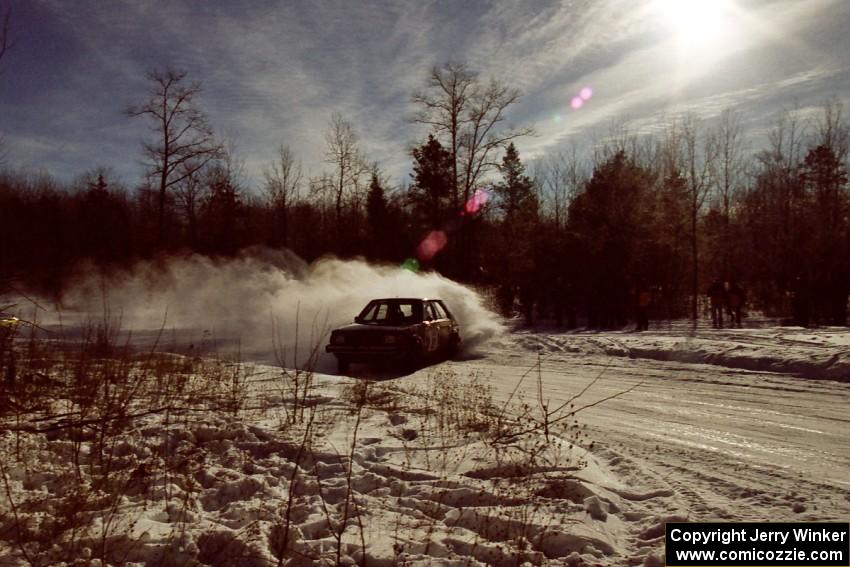 The Mark Utecht / Brenda Corneliusen Dodge Omni GLH-Turbo sets up way in advance at the Hungry 5 spectator corner on SS1.