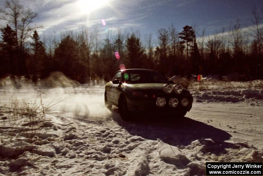 Tad Ohtake / Cindy Krolikowski drift past spectators on SS1, Hungry 5, in their Ford Escort ZX2.