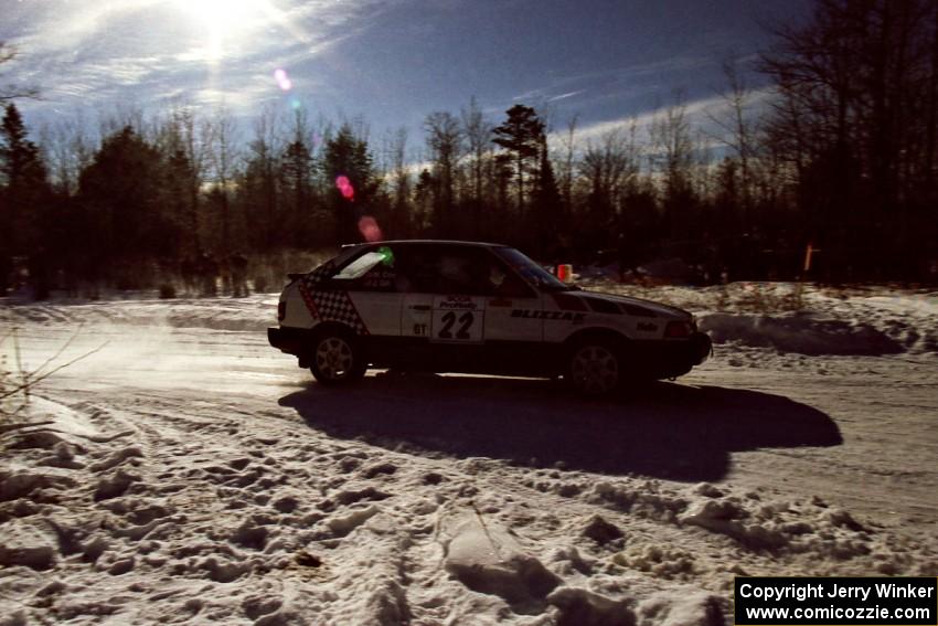 Mark Cox / Jim Gill drift past spectators on SS1, Hungry 5, in their Mazda 323GTX.