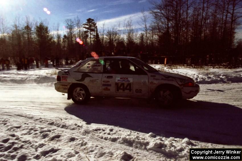 The Charlie Langan / Hughie Langan Ford Escort GT drives past spectators on SS1, Hungry 5.