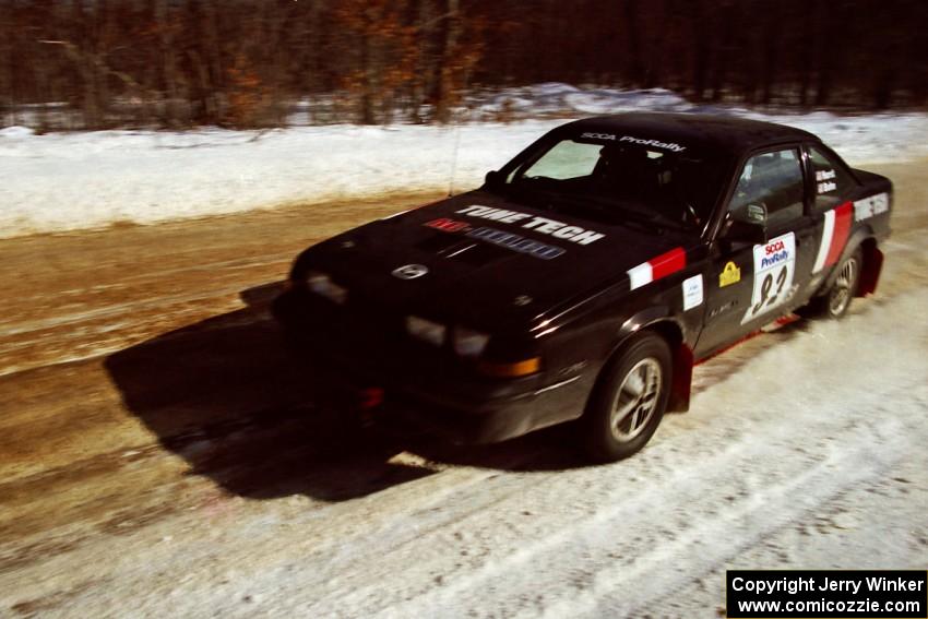 The Mike Hurst / Rob Bohn Pontiac Sunbird Turbo at speed on SS5, Avery Lake I.