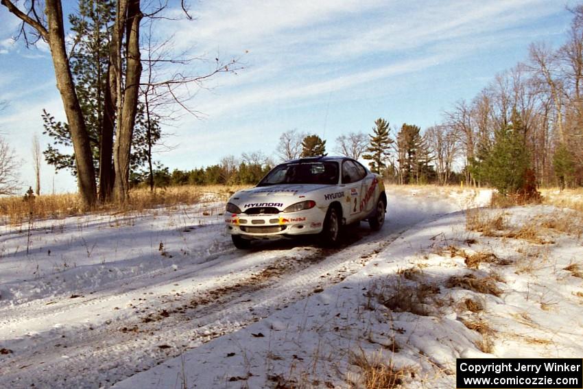 The Paul Choiniere / Jeff Becker Hyundai Tiburon comes over a small crest on SS7, Ranch II.