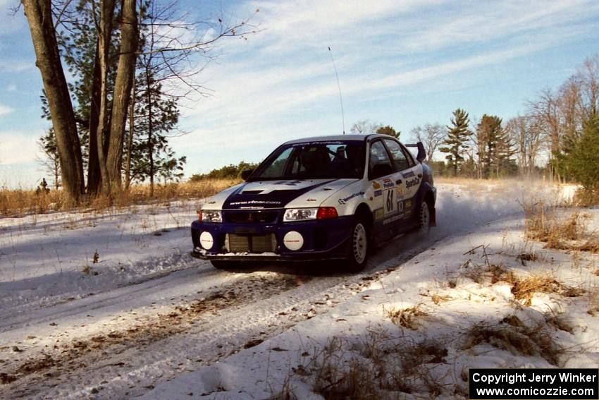 The Karl Scheible / Russ Hughes Mitsubishi Lancer Evo V comes over a small crest on SS7, Ranch II.