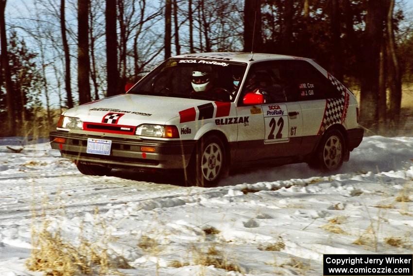 Mark Cox / Jim Gill slow for the hairpin on SS7, Ranch II, in their Mazda 323GTX.