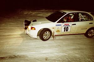 Pete Lahm / Matt Chester drift their Mitsubishi Lancer Evo IV through a 90-left on SS16, the final stage.