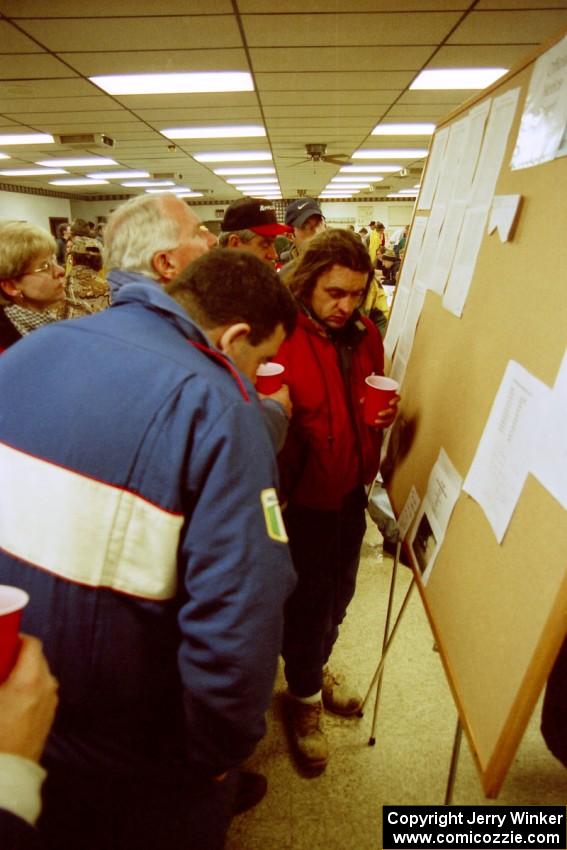 Hughie Langan and a few other drivers check the results.