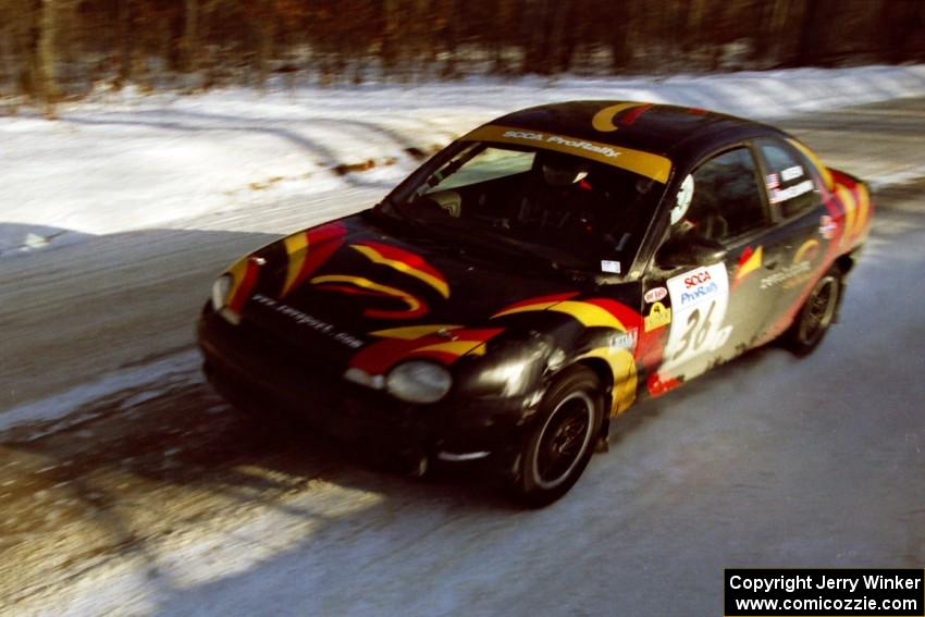 The Evan Moen / Kurt Winkelmann Chrysler Neon at speed on SS9, Avery Lake II, before sunset.