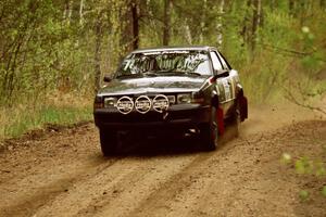 The Mike Hurst / Rob Bohn Pontiac Sunbird Turbo at speed on Indian Creek Rd., SS1.