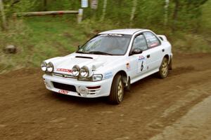 Henry Krolikowski / Cindy Krolikowski drift their Subaru WRX through the first corner of SS1.