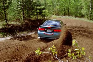 Darek Bosek / Piotr Modrzejewski sling a spray of gravel at the first corner of SS1 in their Eagle Talon.