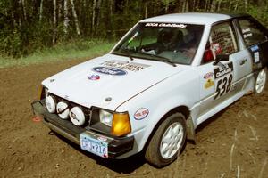 Jim Buchwitz / C.O. Rudstrom drift their Ford Escort through a 90-left on SS1, Indian Creek Rd.