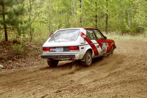 Erik Payeur / Adam Payeur in their Dodge Omni on SS1.