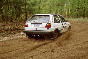 Aaron Hatz / Brendan Higgins spray gravel while drifting through the first corner of Indian Creek Rd., SS1, in their VW GTI.