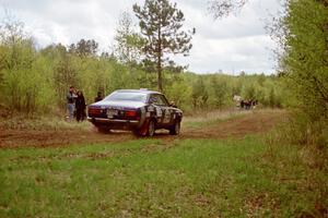 Mark Kleckner / Jeff Hribar get cheered on Indian Creek Rd., SS1, in their Dodge Colt.