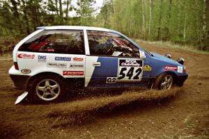 Dan Moore / John Hopponen understeer and plow through the loose gravel in their Suzuki Swift GTi on SS1.