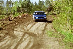 Kendall Russell / Russ Hughes drift their Dodge Shadow through a sweeper in the Two Inlets State Forest.