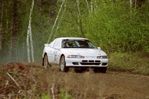 Chris Gilligan / Joe Petersen at speed over a blind crest in the Two Inlets State Forest in their Mistubishi Eclipse GSX.