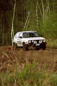 Aaron Hatz / Brendan Higgins at speed over a blind crest in the Two Inlets State forest in their VW GTI.