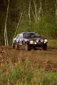 Mark Kleckner / Jeff Hribar at speed through a sweeper in the Two Inlets State Forest in their Dodge Colt.