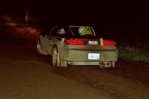 The Steve Nielsen / Jeff Burmeister Plymouth Laser drifts through a 90-right at night.