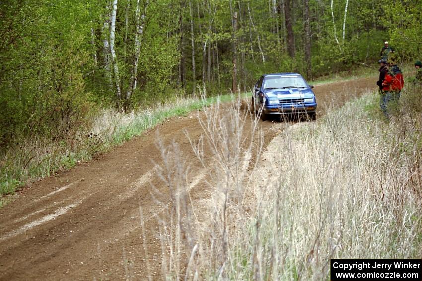 Kendall Russell / Russ Hughes drift their Dodge Shadow through a 90-left on Indian Creek Rd., SS1.