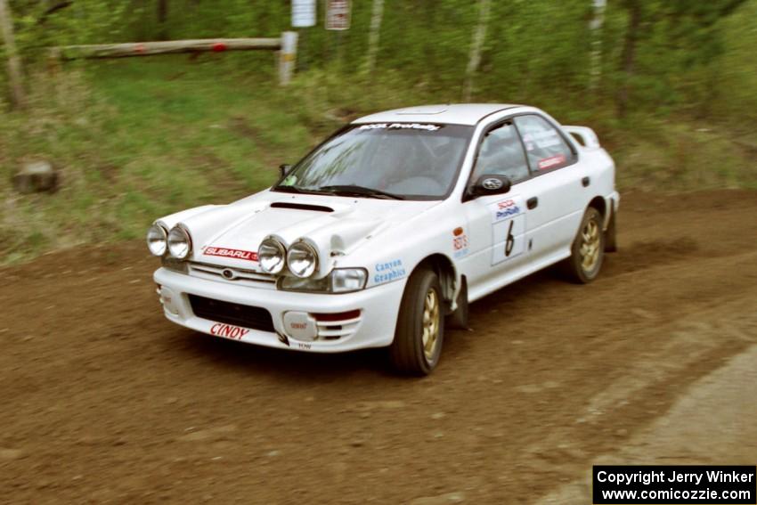 Henry Krolikowski / Cindy Krolikowski drift their Subaru WRX through the first corner of SS1.