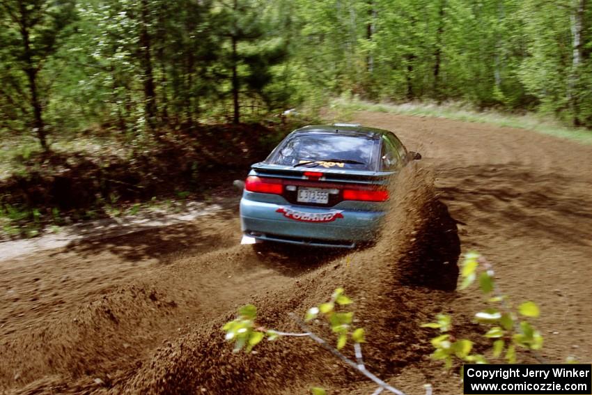 Darek Bosek / Piotr Modrzejewski sling a spray of gravel at the first corner of SS1 in their Eagle Talon.