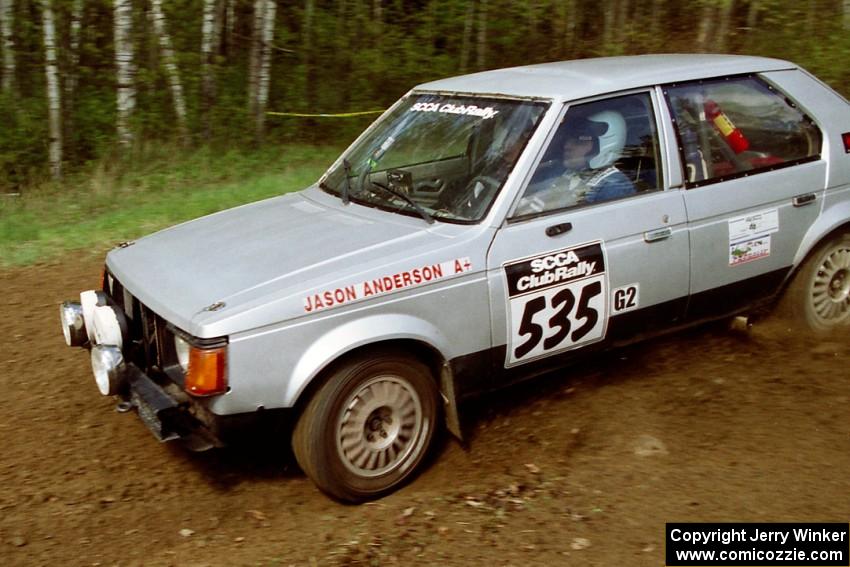 Jason Anderson / Jared Kemp drift their Dodge Omni through the first corner of SS1.