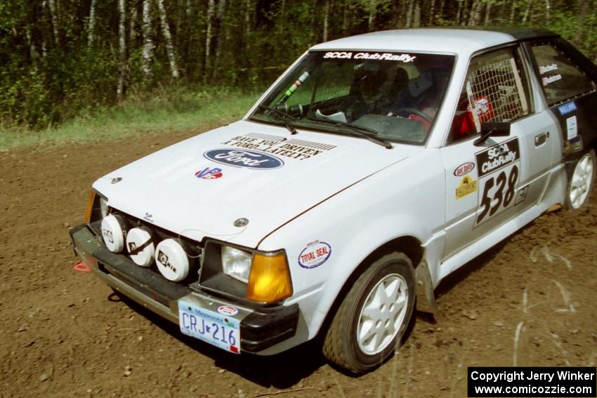 Jim Buchwitz / C.O. Rudstrom drift their Ford Escort through a 90-left on SS1, Indian Creek Rd.