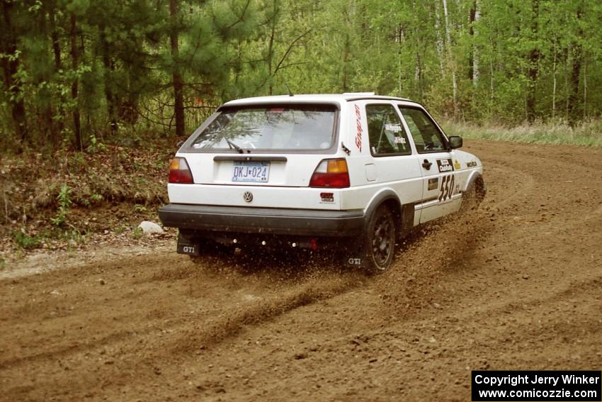 Aaron Hatz / Brendan Higgins spray gravel while drifting through the first corner of Indian Creek Rd., SS1, in their VW GTI.