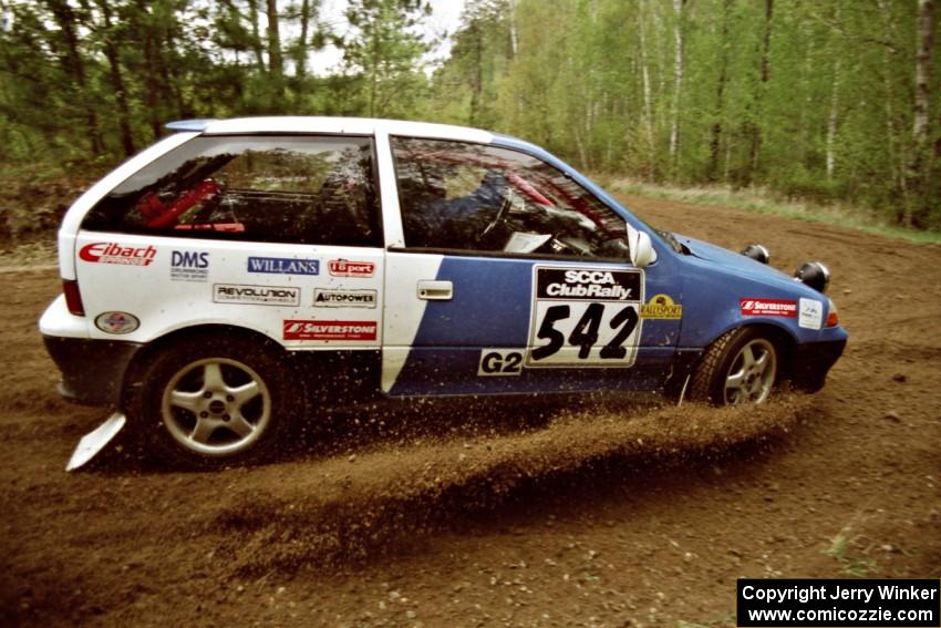 Dan Moore / John Hopponen understeer and plow through the loose gravel in their Suzuki Swift GTi on SS1.