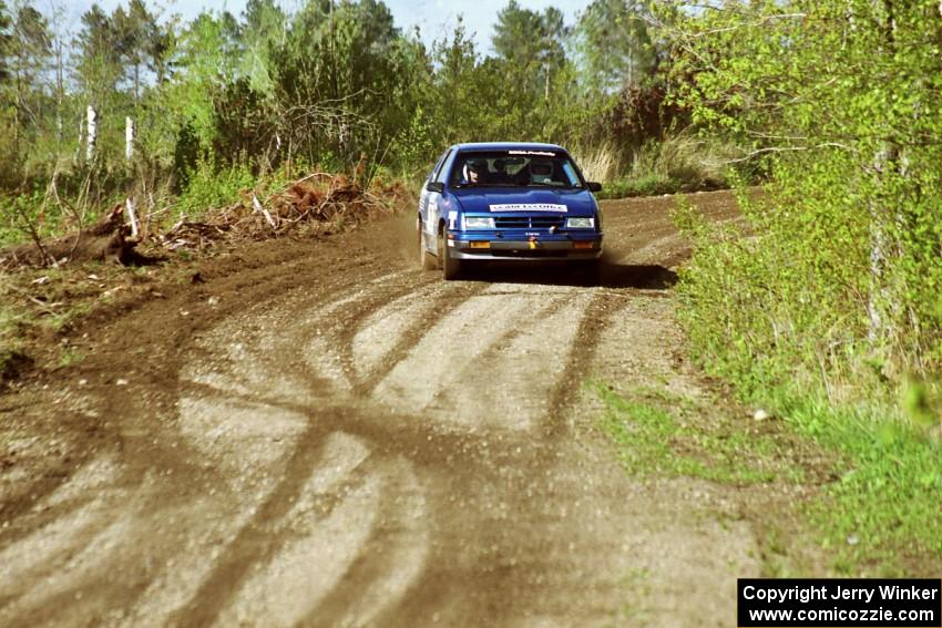 Kendall Russell / Russ Hughes drift their Dodge Shadow through a sweeper in the Two Inlets State Forest.