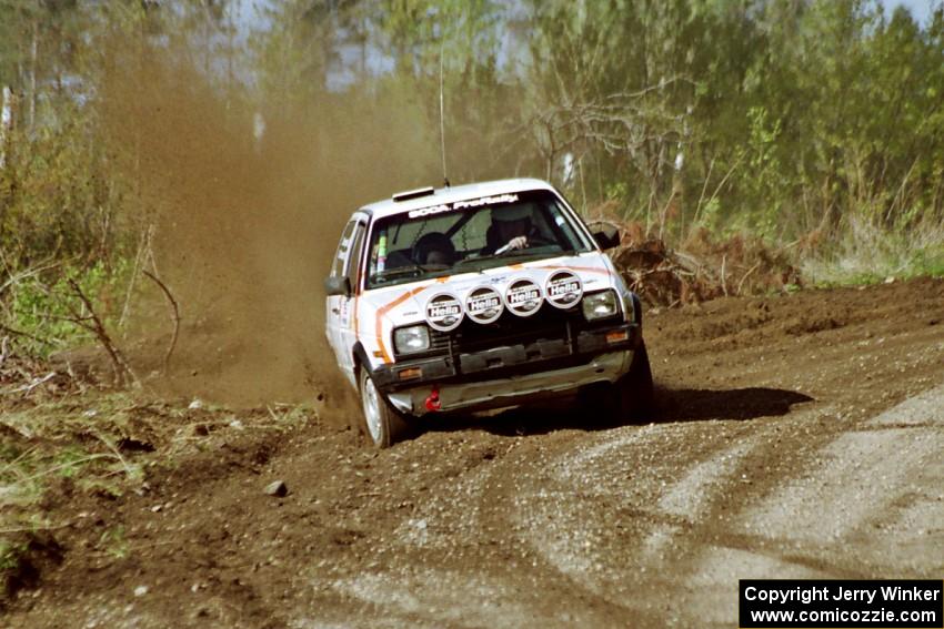 Doug Davenport / Lea Davenport drift their VW GTI wide through a sweeper in the Two Inlets State Forest.