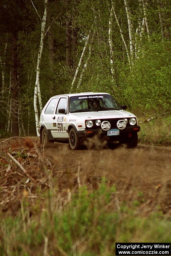 Aaron Hatz / Brendan Higgins at speed over a blind crest in the Two Inlets State forest in their VW GTI.