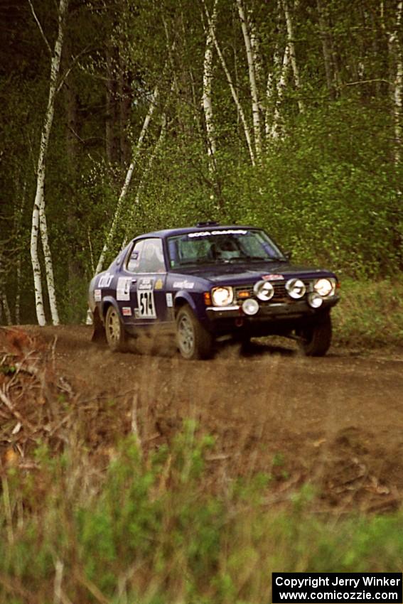 Mark Kleckner / Jeff Hribar at speed through a sweeper in the Two Inlets State Forest in their Dodge Colt.