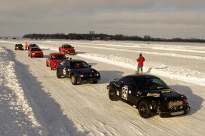 The field lines up in pit lane for the start of a Saturday sprint race.