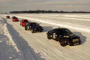 The field lines up in pit lane for the start of a Saturday sprint race.