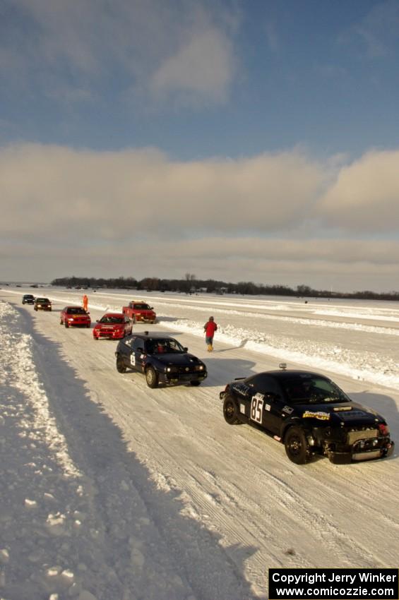 The field lines up in pit lane for the start of a Saturday sprint race.