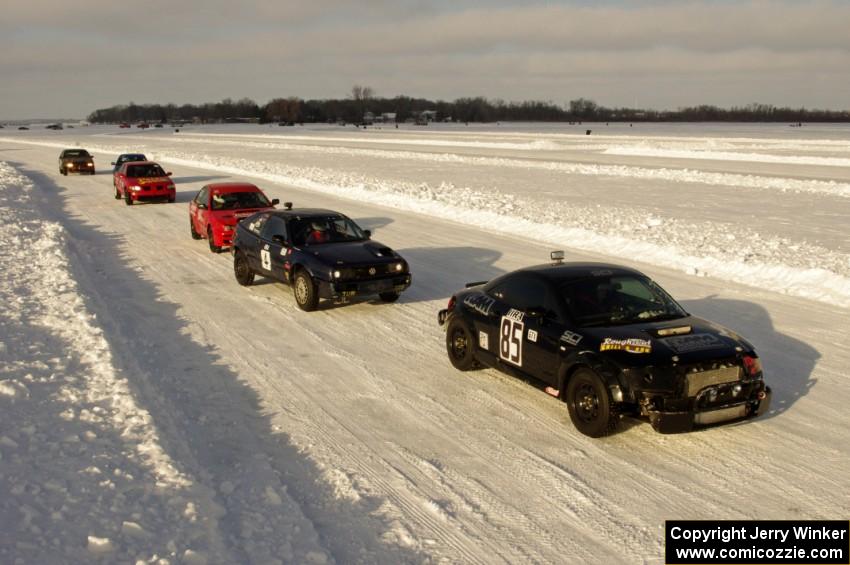 The field lines up in pit lane for the start of a Saturday sprint race.