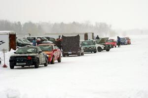 Cars lined up in pit lane between sessions.