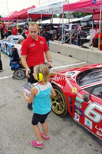 Jeff Segal signs an autograph for a fan in front of his Ferrari 458 Italia