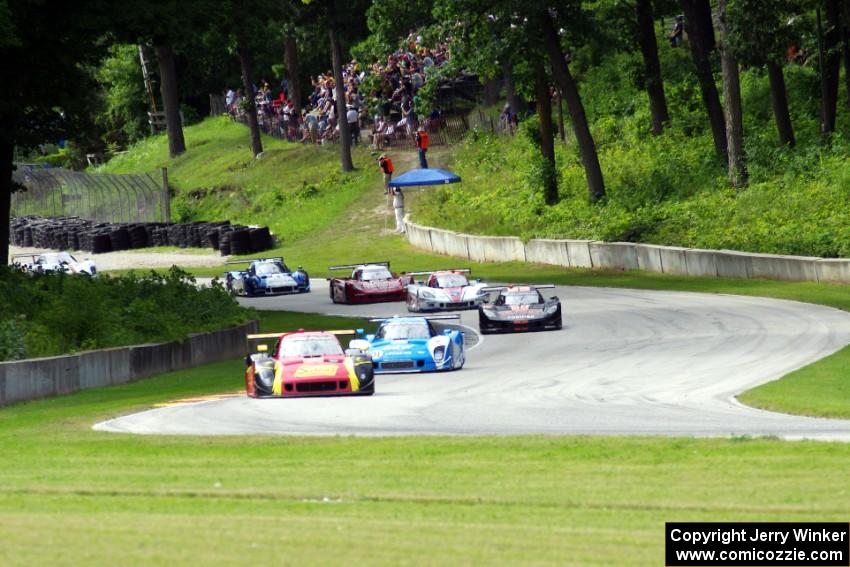 The field streams out of turn 12 into 13 on the first lap.