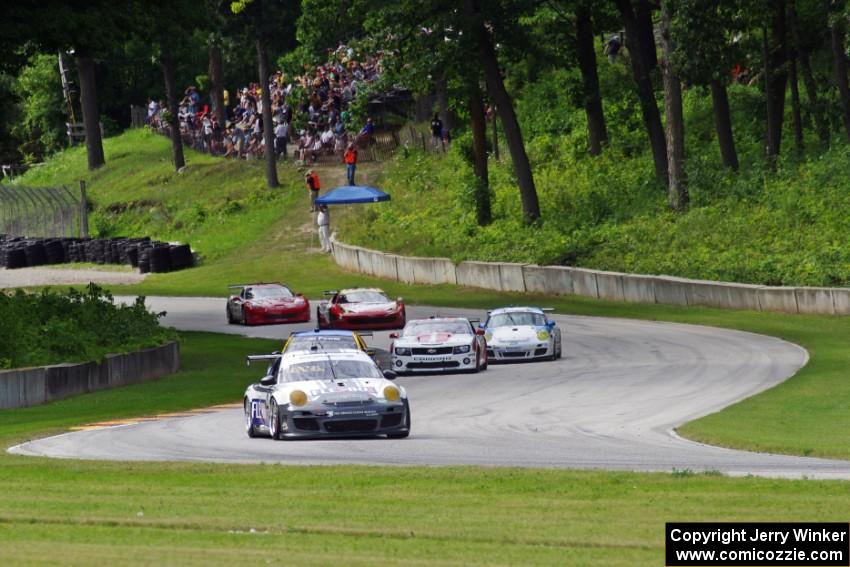 GT cars stream through turns 12 and 13 on the first lap.