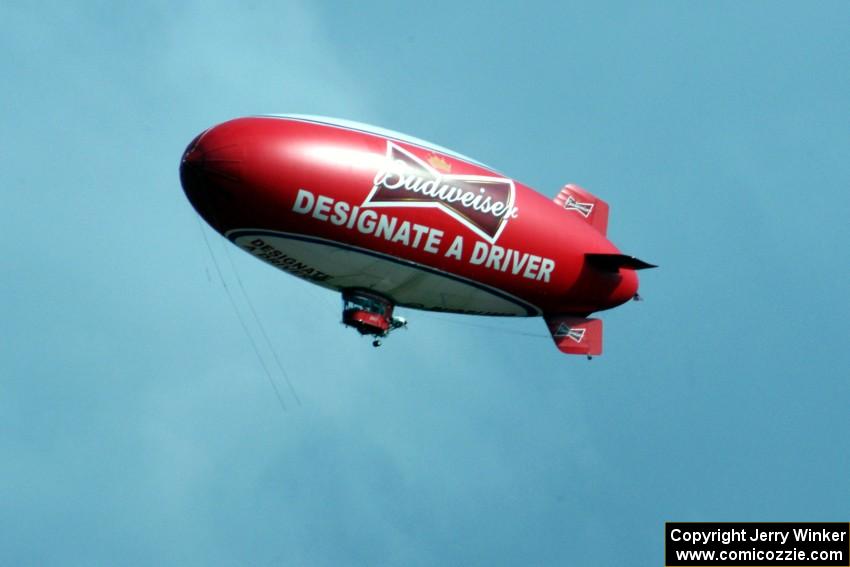 The Budweiser blimp flying overhead.