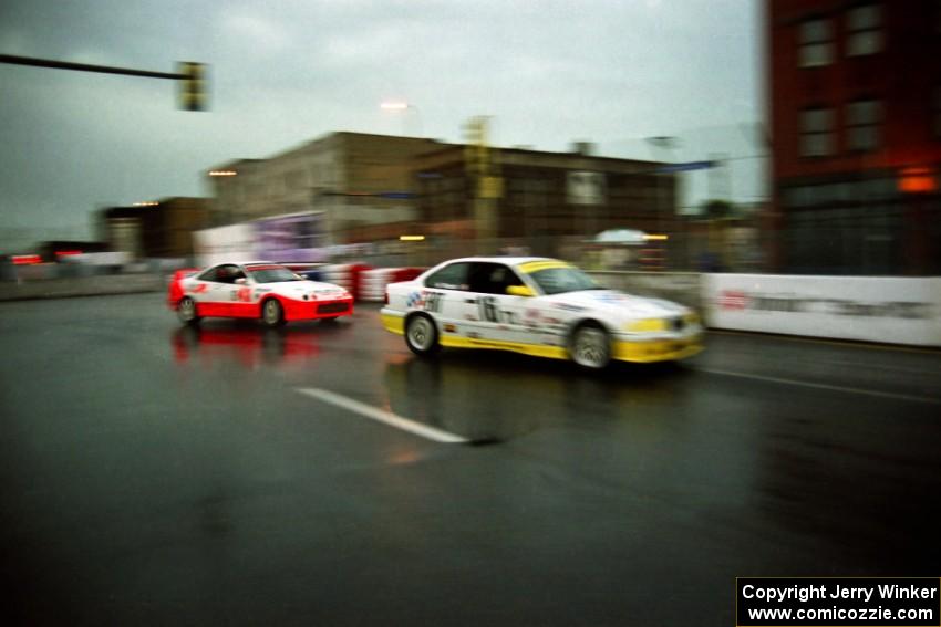 Hugh Plumb's BMW 328is and Michael Galati's Acura Integra Type R battle in the rain