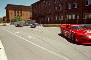 Bob Ruman's Chevy Camaro, Bill Saunders' Chevy Corvette, Randy Ruhlman's Ford Mustang and Lou Gigliotti's Ford Mustang on lap 1