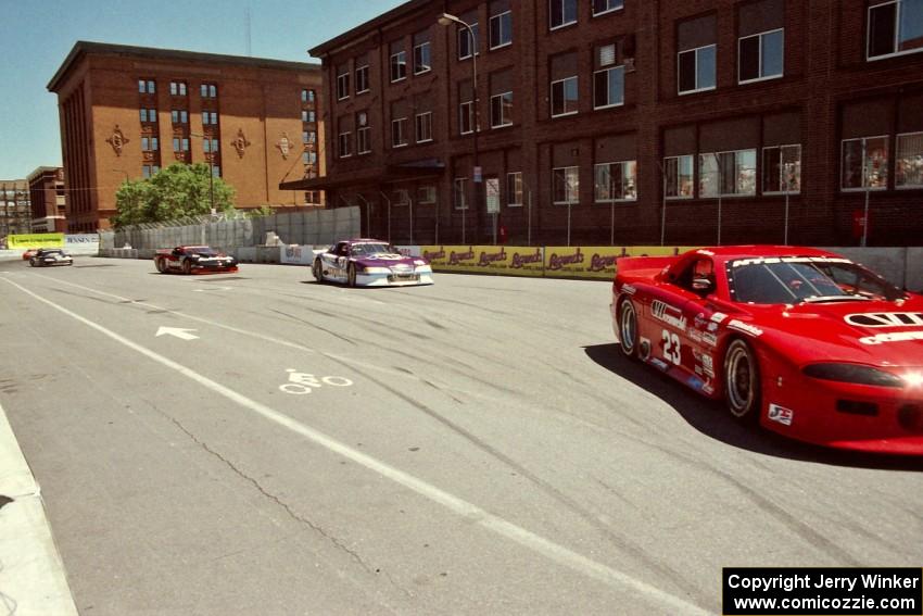 Bob Ruman's Chevy Camaro, Bill Saunders' Chevy Corvette, Randy Ruhlman's Ford Mustang and Lou Gigliotti's Ford Mustang on lap 1