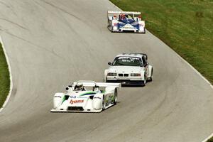 Howard Katz / Jim Downing Kudzu DLY/Mazda leads a pair of cars into turn 7