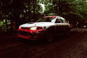 Garen Shrader / Doc Schrader Mitsubishi Lancer Evo IV launches from the start of the practice stage.