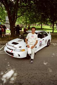 Érik Comas in front of the Mitsubishi Lancer Evo IV he and Julian Masters shared for the event.